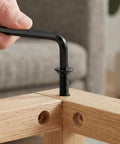 Hand using hex wrench on Top Tier 1/4 20 X 1 Flat Head Socket Screws and Countersunk Bolts in wood joint.