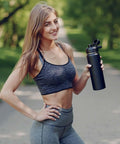 Woman holding 24 Oz Insulated Water Bottle With Handle, 304 Stainless Steel, Wide Mouth, Double Wall Vacuum, BPA Free, in Black