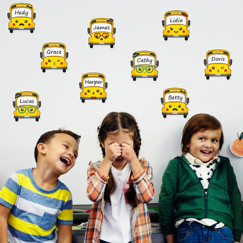 120 Pack School Bus Name Tags In 6 Cartoon Styles for Classroom Use on wall with smiling children, 3.9 x 3.7 inch size, peel and stick.