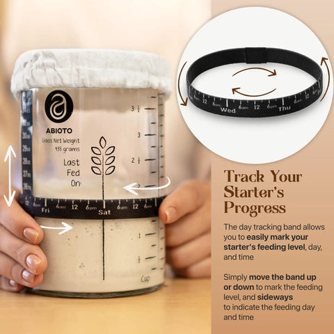 34 Oz Sourdough Starter Jar Kit With Metal Lid Silicone Spatula Feeding Tracker Extra Thermometer Strips And Breathable Covers For Sourdough Bread For Home Bakers shown with tracking band and cloth cover.