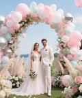 Balloon arch kit with stand and base; pastel pink, white, and blue balloons with floral accents for outdoor wedding.