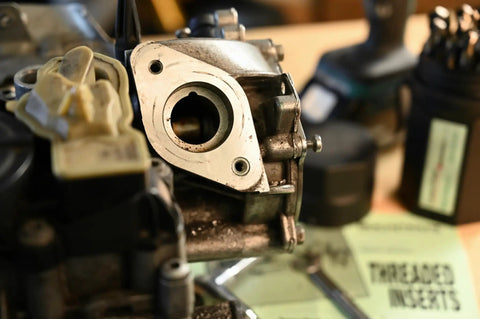 Close-up of self-locking threaded insert kit in use for repair, highlighting heavy-duty fasteners for metal with coarse threads.