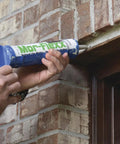 Hand applying Top Shelf Textured Caulk Sealant For Mortar Stucco Repair On Brick Stone Concrete Masonry Beige 10 Point 5 Oz Tube.