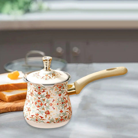 Colorful patterned coffee pot with lid and wooden handle on kitchen counter, ideal for Turkish coffee brewing.