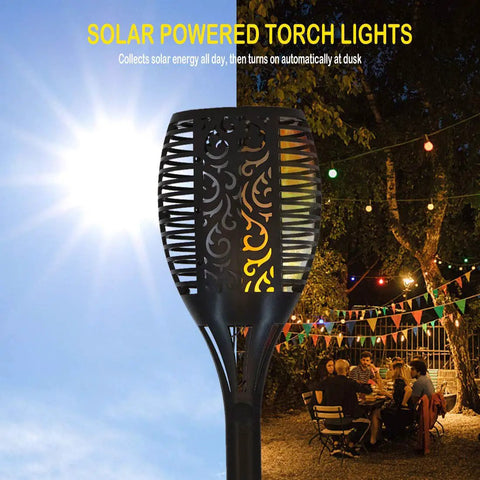 Six Pack Solar Torch Lights With Realistic Flickering Flame LED against sunny sky and outdoor night setting, 31-inch lanterns
