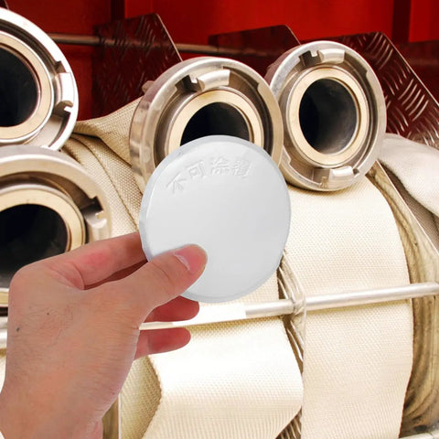 Sleek Iron Fire Sprinkler Nozzle Cover Plate With Tough Head Protector And Snug Ceiling Escutcheon being held, designed to mask holes.