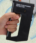 Close-up of a hand holding a Metal Detector - Wire Finder Wall Scanner, Stud Sensor Hardware Tool against a wall.
