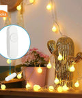 Full Range Inline Dimmer Switch For Dimmable LEDs And Incandescents, white rotary dimmer near glowing string lights on a cactus