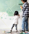 Father and child painting a wall with Six Roll Masking Tape Pack 0.75 Inch By 60 Yards Multi Surface Paper Tape for clean lines.