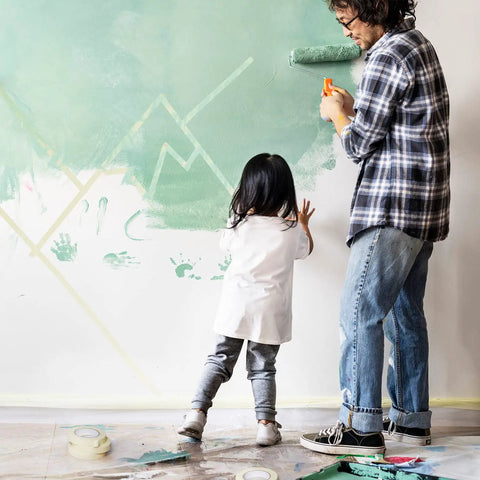 Father and child painting a wall with Six Roll Masking Tape Pack 0.75 Inch By 60 Yards Multi Surface Paper Tape for clean lines.