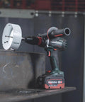 18V Cordless Driver Drill Kit Handles Heavy Demands With Two 18V 5.5Ah Batteries And A Badass Tool Free Quick Change Chuck Featuring Killer Anti Kickback Gyro Protection For Fast Metal Work on metal surface with hole saw.