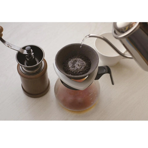 Premium Japanese Ceramic Coffee Filter Reusable Pour Over Dripper With Rock Solid Brown Holder in use with coffee grinder.