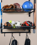 Three Tier Wall Mounted Gear Organizer With Ball Rack Bat And Racket Holders And Four Helmet And Accessory Hooks Heavy Duty Garage Storage In Glossy Black showing sports gear and accessories.