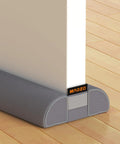 Adjustable Under Door Draft Stopper Gap Filler Cuts For Doors 24 To 32 Inches seals out cold air with gray cover under door.