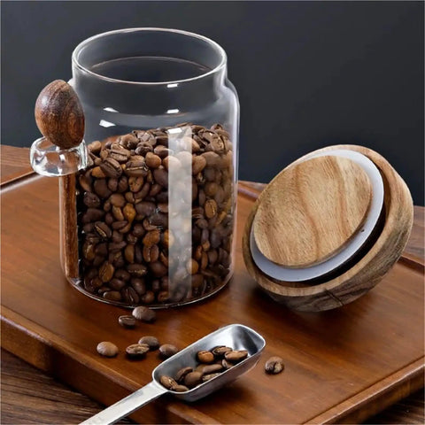 Go Ahead And Upgrade Your Countertop Setup With This Solid Clear Glass Storage Jar Featuring An Airtight Sealed Kitchen Canister And Wooden Spoon For Coffee Beans 900Ml Capacity with coffee beans.