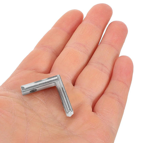 Slick Heavy Duty 2020 Series L Shaped Corner Brackets For Dead Simple Aluminum T Slot Assembly in a hand for scale.