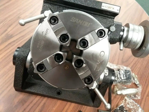 Heavy Duty Eight Inch Precision Tilting Rotary Table With No Fuss Zero To Ninety Degree Tilt Capability And Four Jaw Self Centering Chuck setup on a workbench.