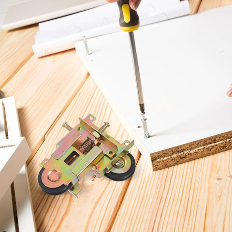 Closet Door Rollers Replacement With Ball Bearing Wheels and adjustable height, shown during installation on wood panel.