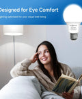 A woman relaxed on a sofa reading under A19 LED Light Bulbs 60W Equivalent, 5000K Daylight White, E26 Base, Non Dimmable design for eye comfort.