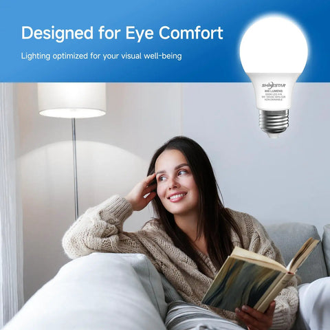 A woman relaxed on a sofa reading under A19 LED Light Bulbs 60W Equivalent, 5000K Daylight White, E26 Base, Non Dimmable design for eye comfort.