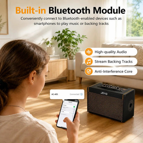 Person connecting phone to 40W Acoustic Guitar Amplifier With Bluetooth And Battery Powered Portable Stereo Speaker in living room