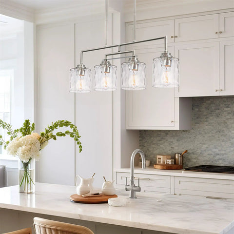 Monroe 28 Inch Modern Four Light Linear Kitchen Island Light with Hammered Glass Shades in Brushed Nickel over kitchen island.