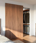 Solid As A Rock Concealed Sliding Barn Door Hardware Kit with smooth soft close action, showcased in a modern room.