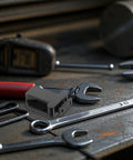 Eight Pack Push To Open Cabinet Latches Black Hidden Push Touch Latch on workshop table with tools and bolts
