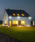 JUDYSSY Outdoor Led Floodlights with Remote Control illuminating a modern house at night, showcasing bright garden lighting.