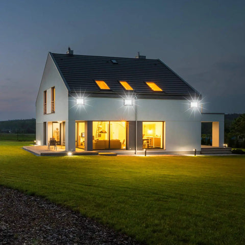 JUDYSSY Outdoor Led Floodlights with Remote Control illuminating a modern house at night, showcasing bright garden lighting.