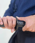 Close-up of hands gripping 39 Inch Polypropylene Martial Arts Training Sword with Black Saya Scabbard for safe training.