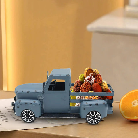 Blue Metal Pickup Truck Decor For Farmhouse Tables carrying colorful decorative balls, displayed on a tabletop