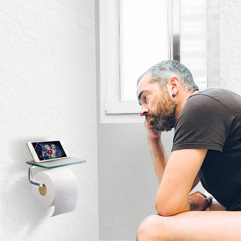 Man using Anti Rust Toilet Paper Holder With Shelf And Phone Storage Rack, Wall Mounted Tissue Dispenser In Frosted Silvery Steel Finish
