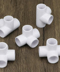 Four Way PVC Fittings Half Inch Eight Pack Furniture Grade Pipe Connectors Elbow PVC Corner Fittings With Deep Sleeves For A Sturdy Do It Yourself Setup displayed on wooden surface
