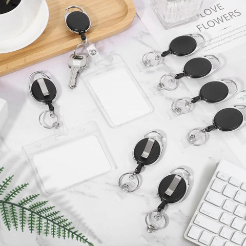20 Pack Retractable Badge Reels With Carabiner, Heavy Duty ID Badge Holders And Key Chain Clips displayed on a desk