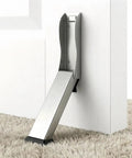 Heavy Duty Kickdown Door Stopper For Bottom Of Door, Hands Free Knock To Lock Design And No Bend Required, sleek brushed stainless steel door stopper on white door.