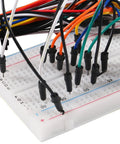 Close-up of Awesome Breadboard Kit With Power Supply Module And 830 Point And 400 Point Solderless Boards 130 Piece Flexible Jumper Wires 9V Battery Clips T Type For Raspberry Pi And DIY Electronics Projects with jumper wires.