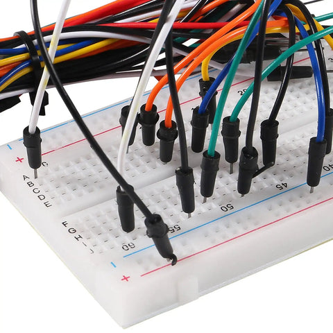 Close-up of Awesome Breadboard Kit With Power Supply Module And 830 Point And 400 Point Solderless Boards 130 Piece Flexible Jumper Wires 9V Battery Clips T Type For Raspberry Pi And DIY Electronics Projects with jumper wires.