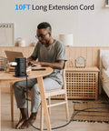 Man using laptop with 10-Foot Power Strip Tower with Eight Outlets and Five USB Ports, Dope Surge Protector on desk.