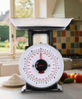 11 Lb Analog Kitchen Scale With Stainless Steel Bowl on a kitchen counter, showing mechanical food weighing dial and removable bowl