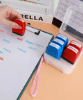 Nifty Six Piece Self Ink Rubber Stamp Set With Vivid Red And Navy Blue Office Stamps on a clipboard for efficient marking.
