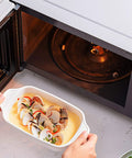 Cooking dish beside Universal 12.4 Inch Microwave Glass Turntable Plate Replacement for Most Models 315mm Round Tray