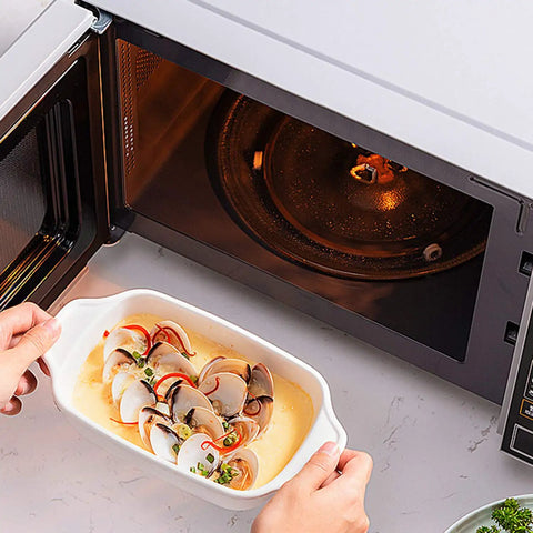 Cooking dish beside Universal 12.4 Inch Microwave Glass Turntable Plate Replacement for Most Models 315mm Round Tray