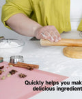 Person rolling dough beside spices and flour in kitchen using Beast 2000W Grain Grinder Mill With 550g Capacity Stainless Steel High Speed Pulverizer For Dry Wheat Oats Corn Pepper And Coffee Beans Home Kitchen Workhorse.