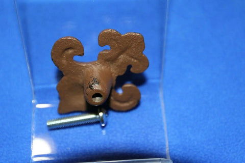 Old School Vintage Fleur De Lis Cabinet Knobs Set, Cast Iron Victorian Style Hardware, brown iron knob back view on blue surface