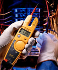 Non Contact Voltage And Current Tester With Auto AC DC Detection, Measures Up To 600 V And 100 A, in use by electrician.