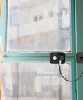 Multifunction Safety Cabinet Lock With Key For Cabinets And Fridges Black Plastic Door Lock And Window Limiter shown installed on window
