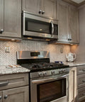 Kitchen scene featuring Weathered Nickel Drawer Handles Six Pack With 5.04 Inch Center To Center Antique Iron Cabinet Pulls on cabinets.