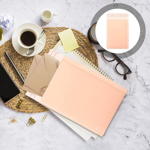 Heavy Duty Bubble Mailers 13x18 And 4 Inch Foam Padding on a desk with office supplies
