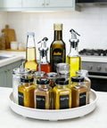 Smooth Spinning White Metal Lazy Susan Turntable Two Pack Compact Rotating Kitchen Cabinet Organizer And Countertop Rack For Pantry Storage straight up with spices and oils.